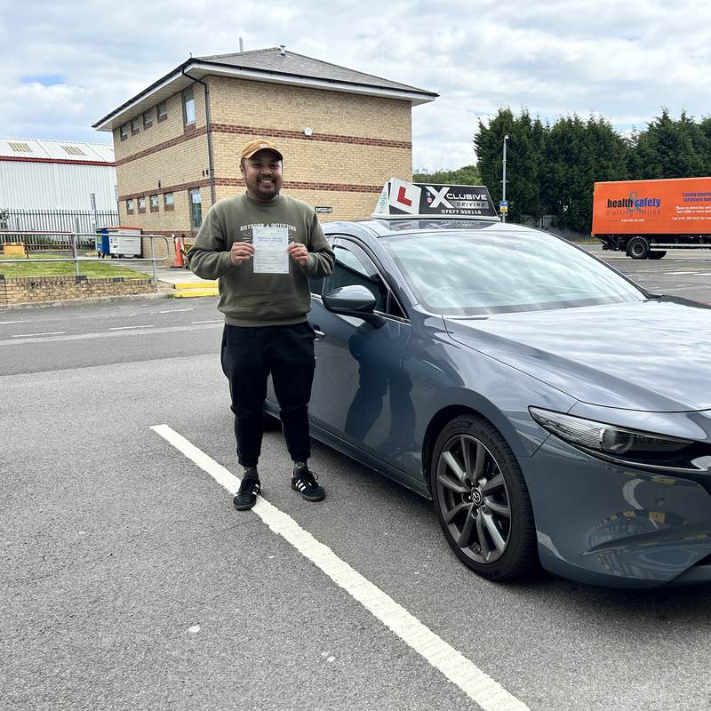 A learner driver with their DVSA pass certificate next to the Xclusive Driving Mazda 3