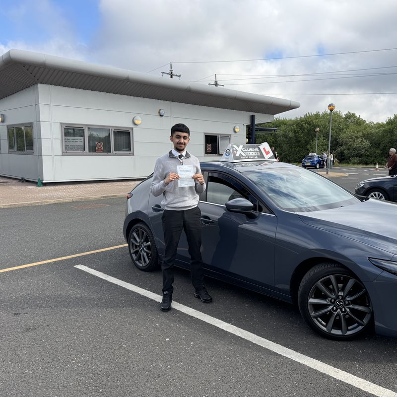 An Xclusive Driving pupil with their DVSA practical test pass certificate at the test centre