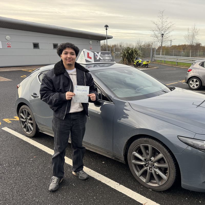 An Xclusive Driving pupil holding their pass certificate next to the Mazda 3 tuition car